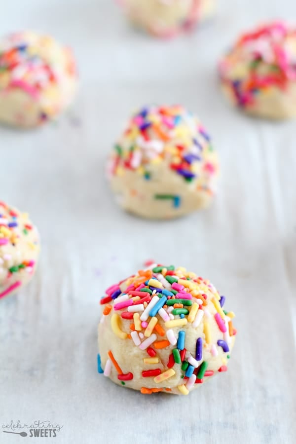 Cookie dough balls on a baking sheet.