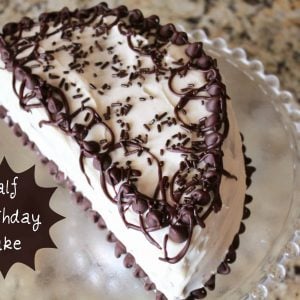 Half birthday cake on a glass plate.