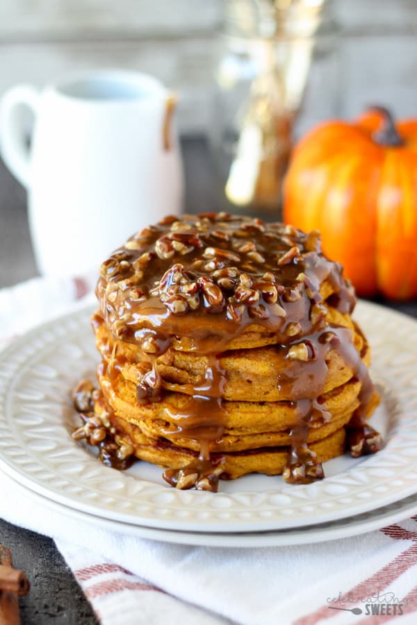 Stack of pumpkin pancakes topped with pecan syrup.