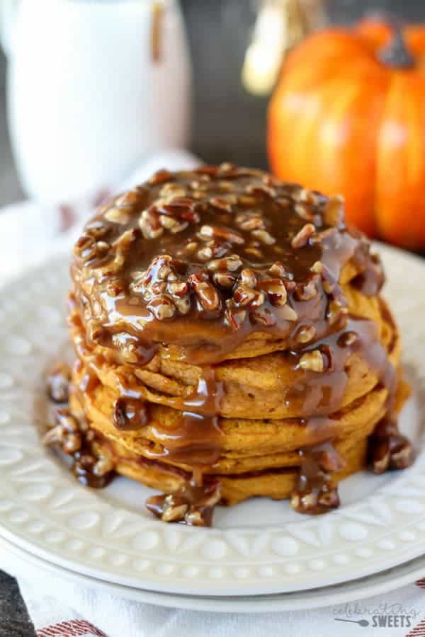 Stack of pumpkin pancakes topped with pecan syrup.