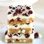 Cranberry White Chocolate Bars - Soft blondies filled with dried cranberries and white chocolate chips and topped with a white chocolate cream cheese frosting (similar to Starbucks Cranberry Bliss Bars). A fantastic holiday dessert!