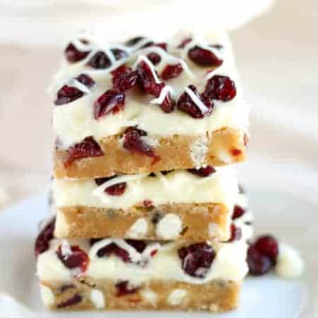 Cranberry White Chocolate Bars - Soft blondies filled with dried cranberries and white chocolate chips and topped with a white chocolate cream cheese frosting (similar to Starbucks Cranberry Bliss Bars). A fantastic holiday dessert!