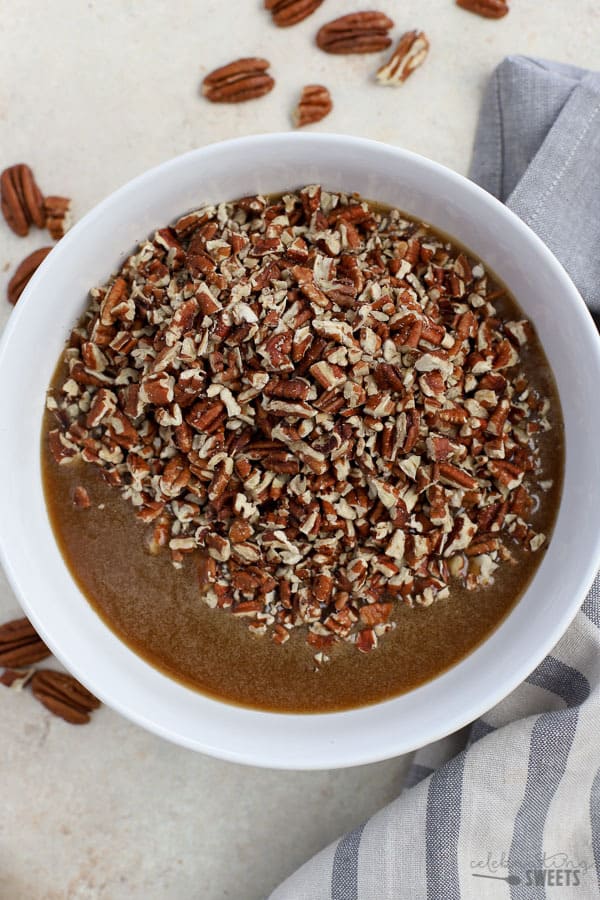 Filling for pecan pie bars in a white bowl.