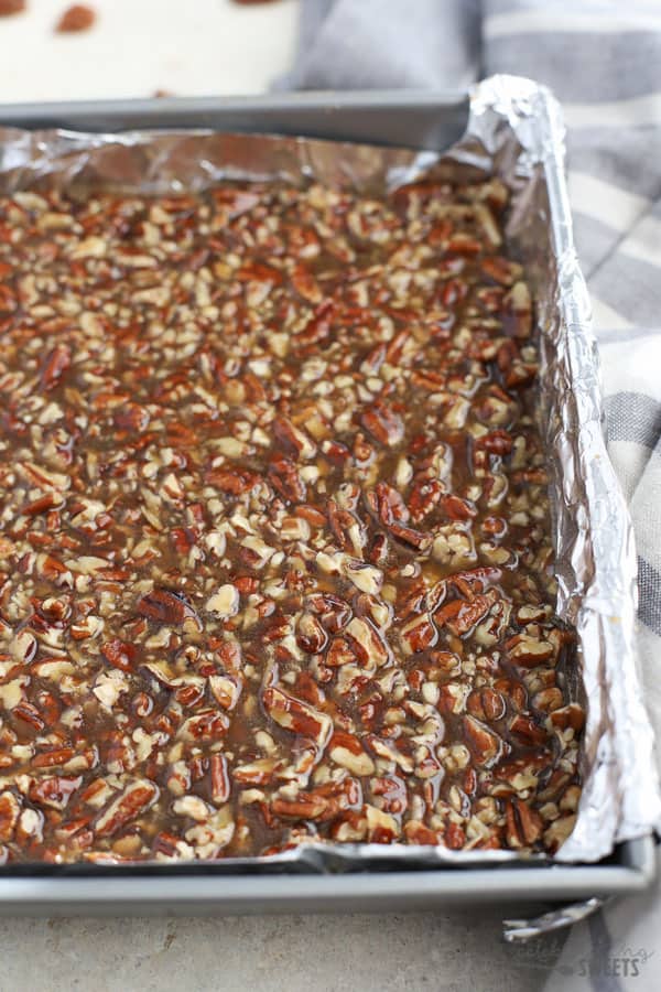 Maple Pecan Bars in a foil-lined baking pan.