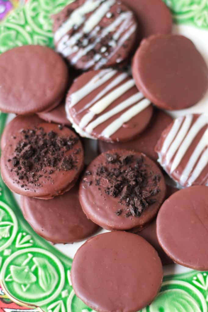 Chocolate cookies on a green and white plate. 