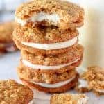Stack of carrot cake cookies filled with frosting.