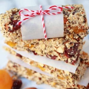 Stack of granola bars on pieces of parchment paper.