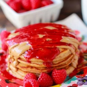 Stack of pancakes topped with melted peanut butter and jelly.