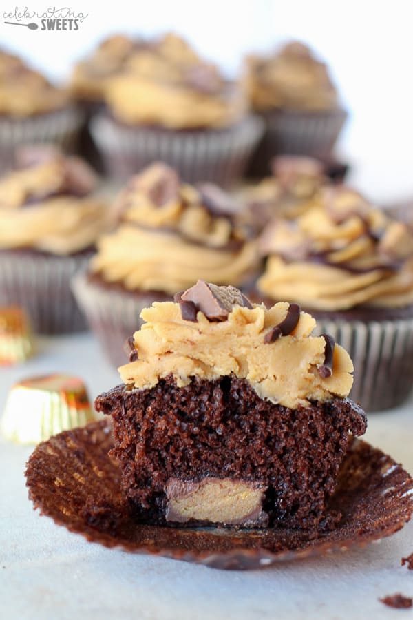 Chocolate cupcakes with peanut butter frosting topped with chopped peanut butter cups. 