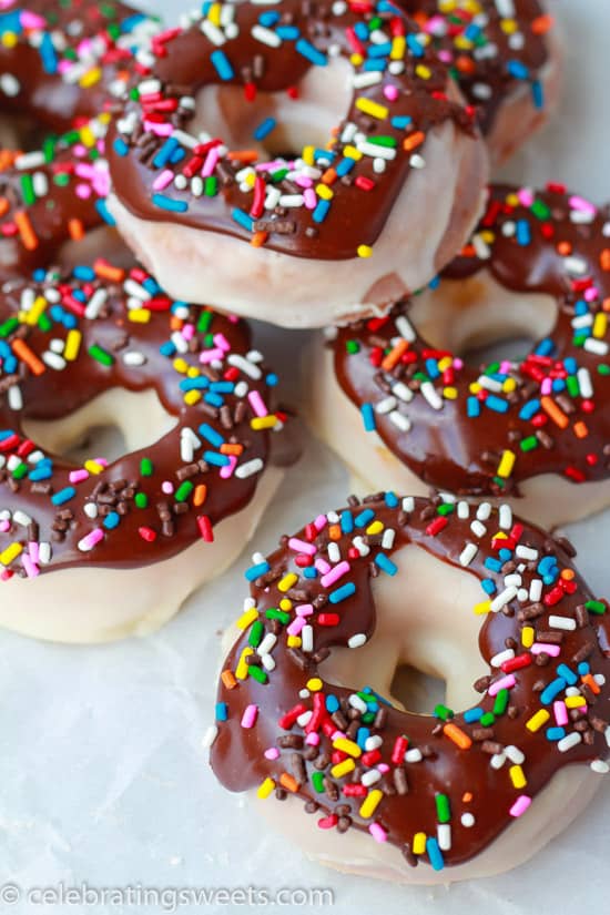 Donuts covered in chocolate glaze and colored sprinkles.