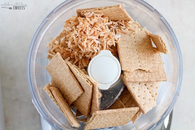 Graham crackers and coconut in a food processor.