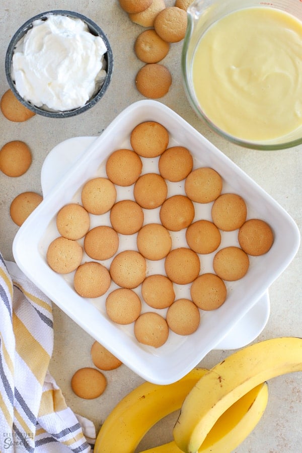 Ingredients for banana pudding: wafer cookies, vanilla pudding, whipped cream and bananas.