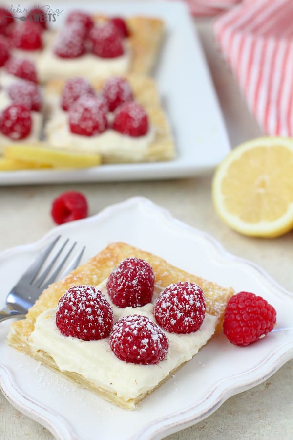 Slice of a Lemon Tart topped with Raspberries.