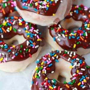 Donuts covered in chocolate glaze and colored sprinkles.
