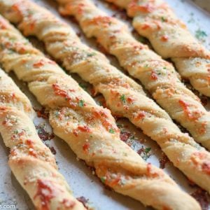 Twisted breadsticks on a baking sheet.