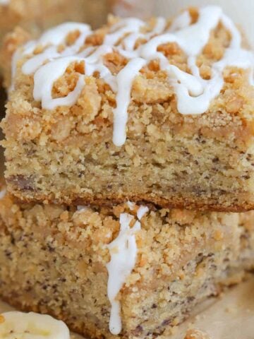 Two slices of banana cake topped with icing.