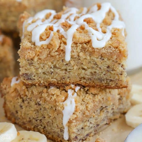 Two slices of banana cake topped with icing.