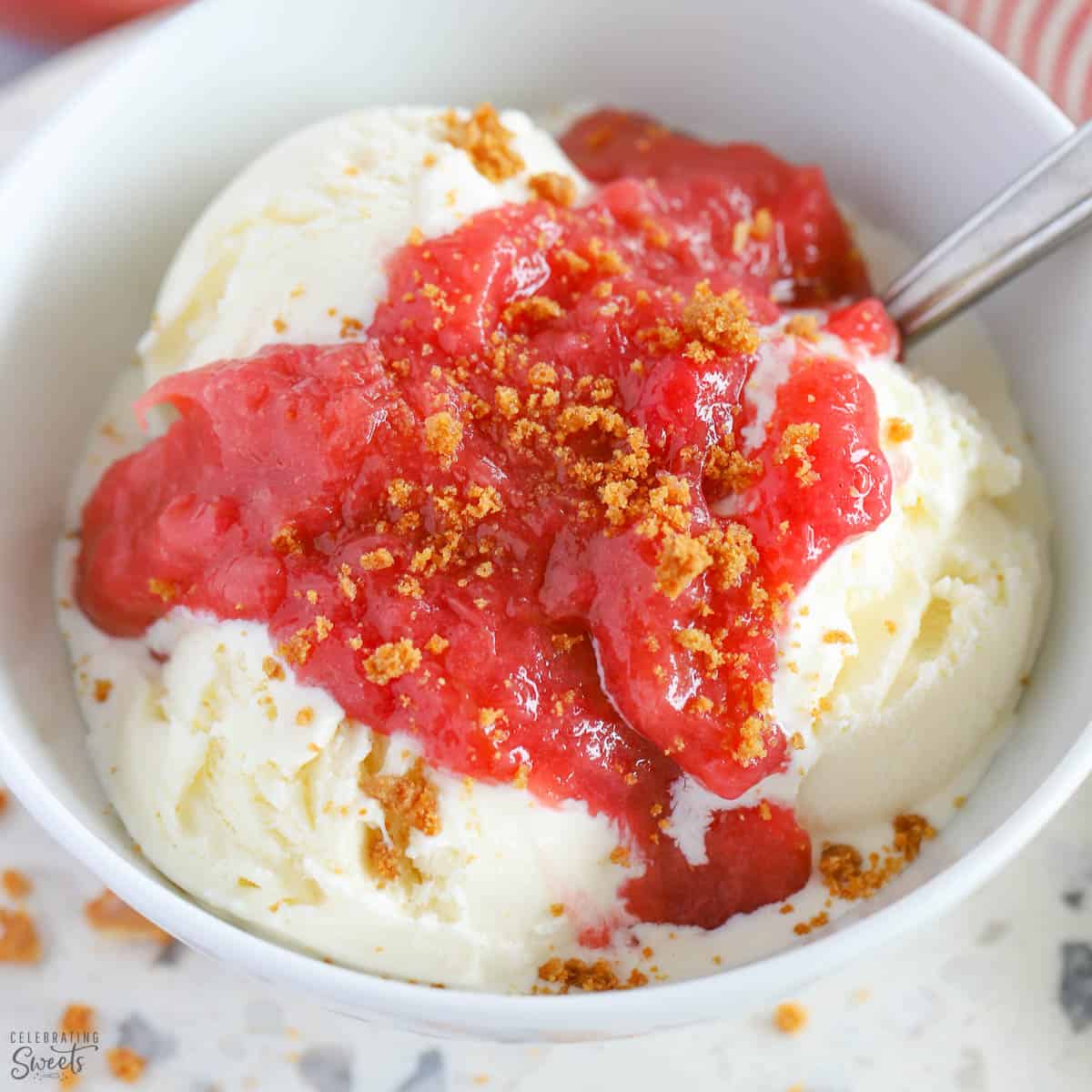 Rhubarb Sauce over vanilla ice cream in a white bowl.