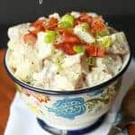 Bowl filled with potato salad topped with bacon.
