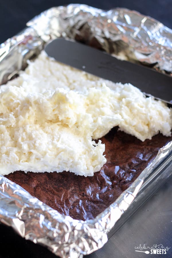 Pan of brownies topped with creamy coconut. 