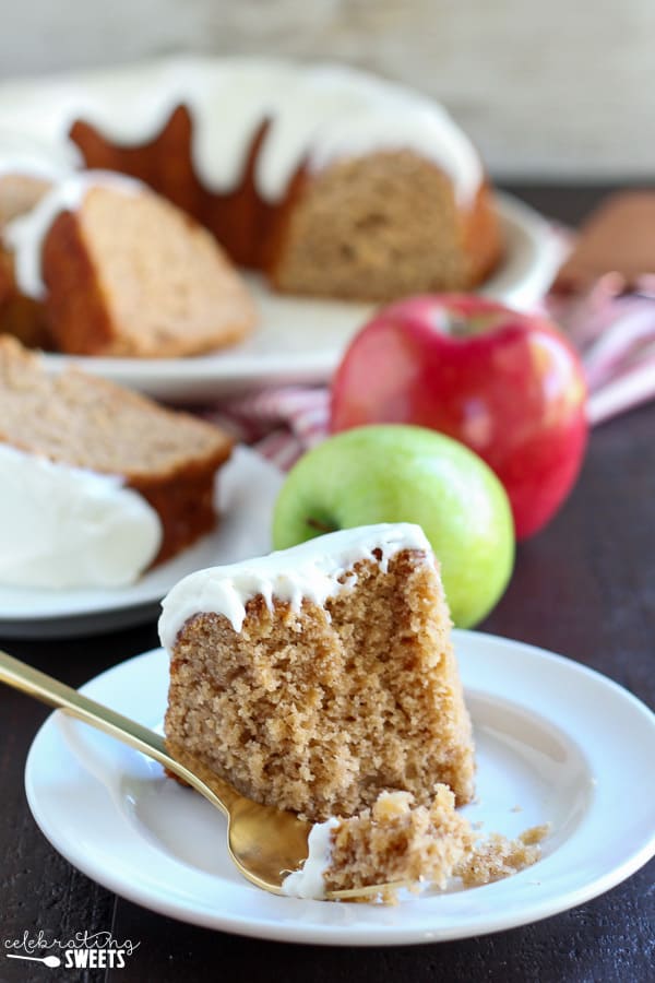 Slice of apple bundt cake on a white plate. 