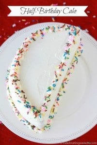 Half birthday cake on a white plate.