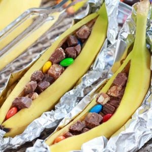 Bananas sliced open and filled with chopped candy.