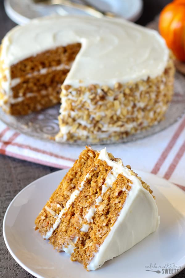 Three layer carrot cake on a white plate. 