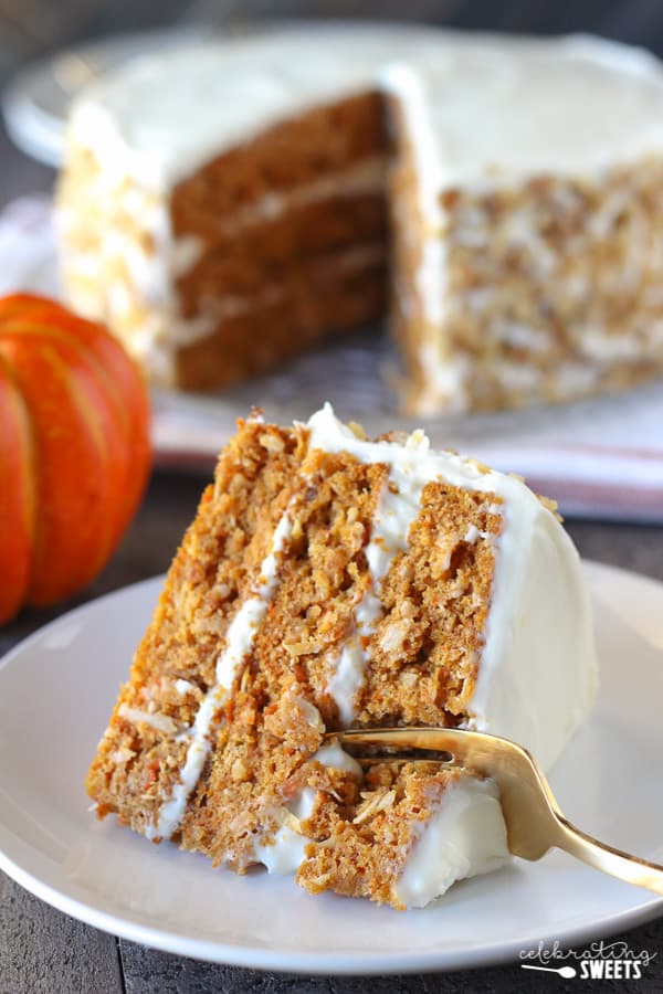 A piece of pumpkin carrot cake on a white plate.