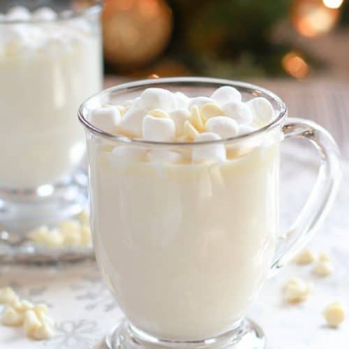 Glass mug filled with white hot chocolate.