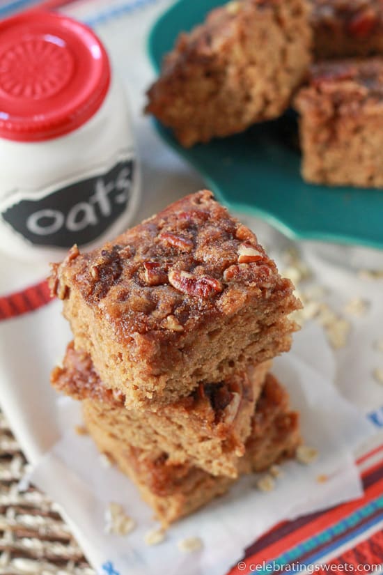 Square slices of cake topped with pecans.