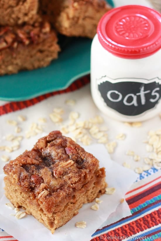 Square slice of oatmeal cake topped with pecans. 