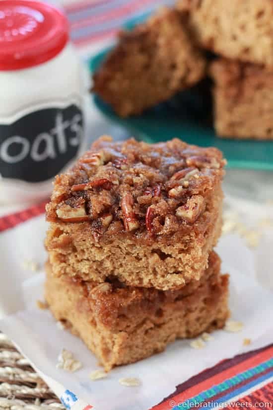 Two slices of cake topped with pecans.