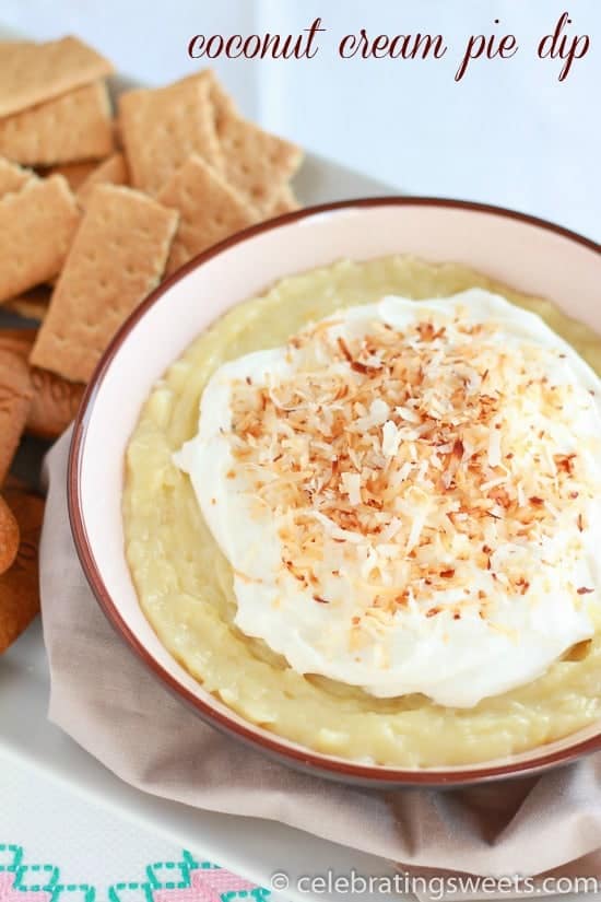 Bowl of coconut pie dip topped with whipped cream and toasted coconut.