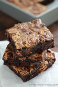 Stack of three brownies with a peanut butter swirl. 