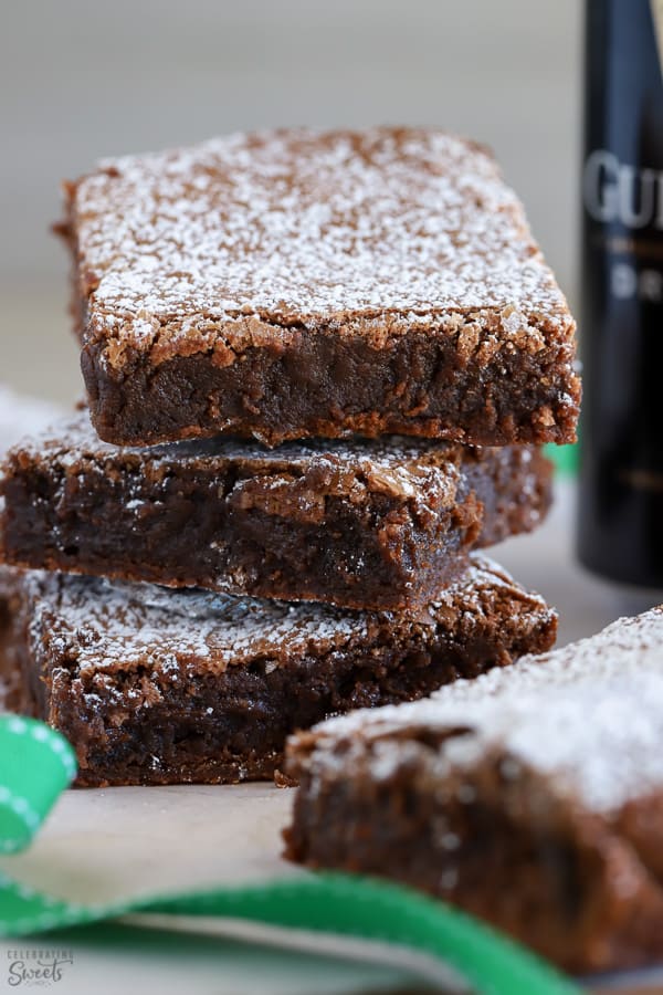 Stack of three Guinness Brownies topped with powdered sugar.
