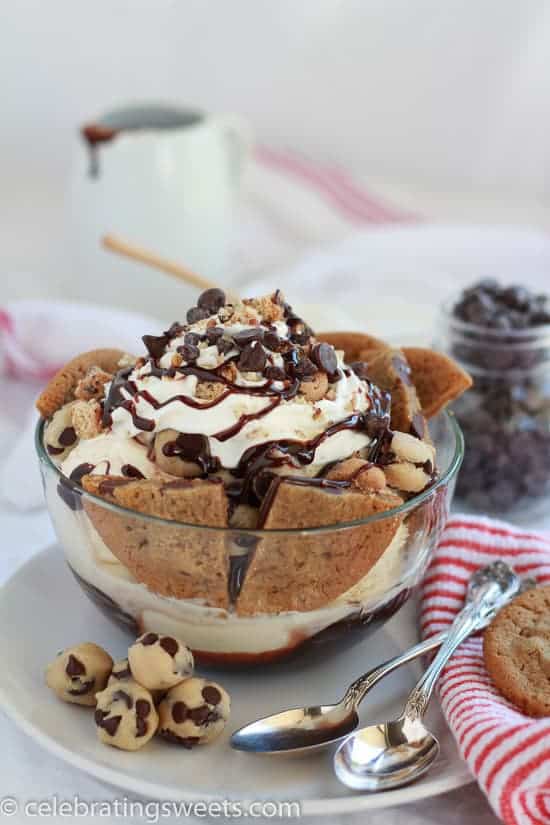 Large bowl of ice cream with chocolate chip cookies and fudge sauce. 