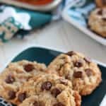 Coconut chocolate chip cookies on a green plate.
