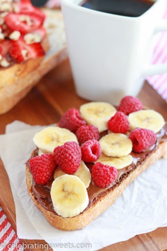 Bread topped with chocolate spread and fresh fruit. 