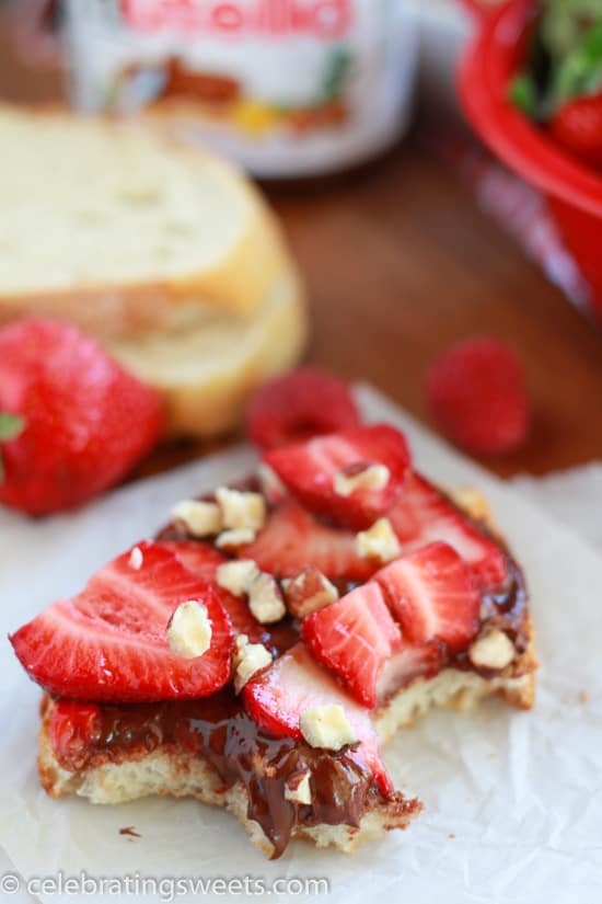 Bread topped with chocolate spread and fresh fruit. 