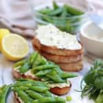 Toasted bread with ricotta cheese and snap peas.