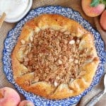 Peach galette on a white and blue plate.