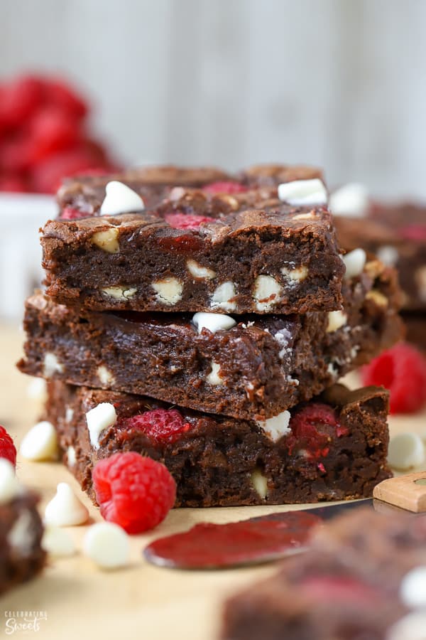 Three raspberry brownies stacked on top of each other.