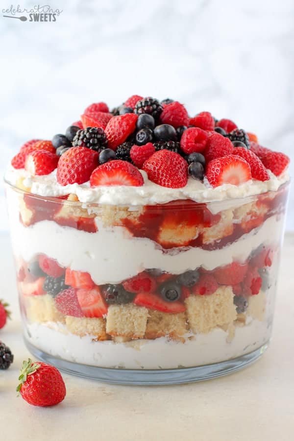 Large trifle dish with layers of berries, cake and whipped cream.