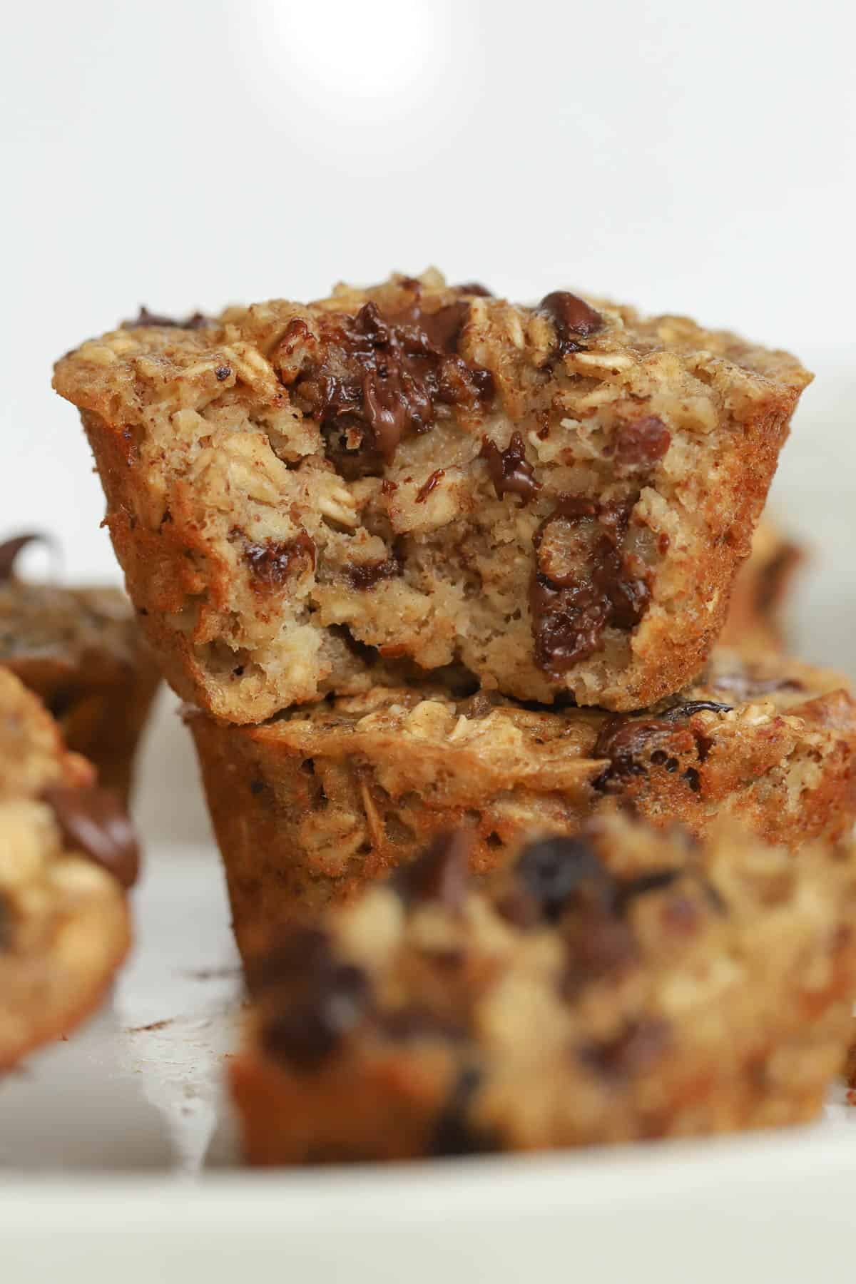 Stack of two baked oatmeal cups filled with chocolate chips.