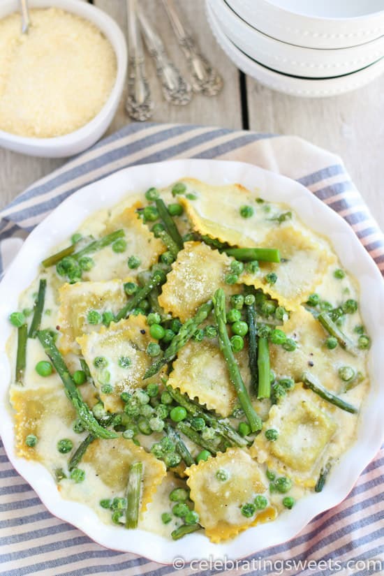 Ravioli with peas and asparagus in a baking dish.