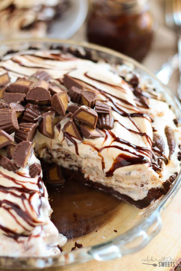 Peanut butter ice cream pie topped with fudge sauce and chopped peanut butter cups.