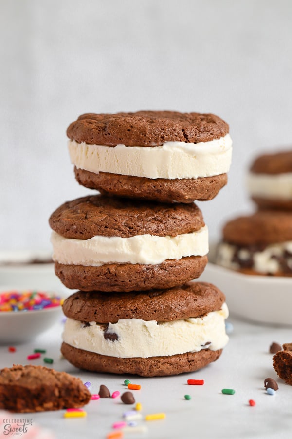 Stack of three ice cream sandwiches on a grey table.
