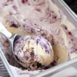 Blackberry vanilla ice cream in a metal loaf pan.