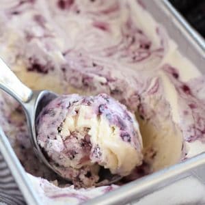 Blackberry vanilla ice cream in a metal loaf pan.